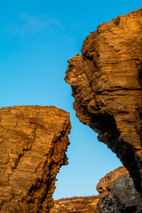 Low Angle View of Rock Formation Against Clear Blue Sky