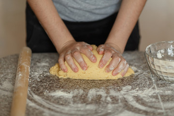 Obraz na płótnie Canvas Baker kneading dough in flour on table