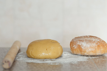 Dough, bread in flour on the table