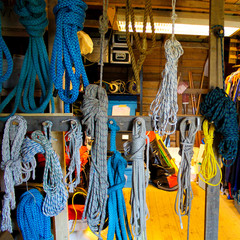 A collection of different kinds of ropes in a wooden warehouse