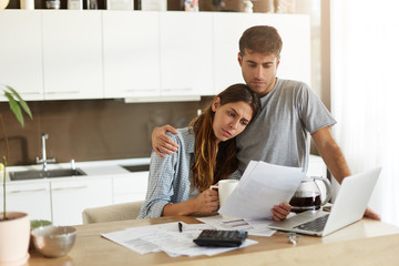 Negative human emotions. Financial problems. Portrait of unhappy young couple having looking...