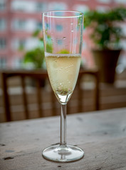 Champagne glass on wood table at home.