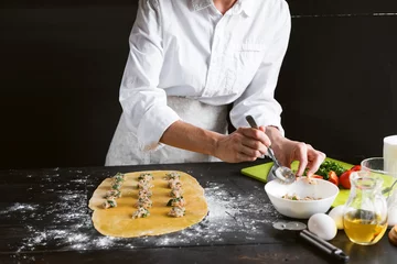 Foto op Canvas Woman chef cooks step by step the traditional ravioli © Mikhaylovskiy 