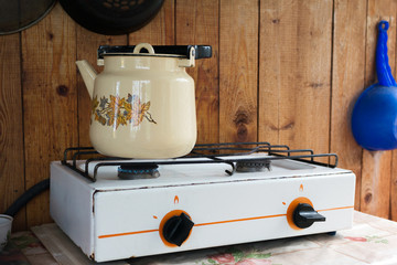 Enameled kettle on the gas stove