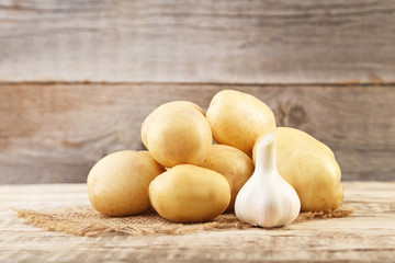 Potatoes with garlic on grey wooden table