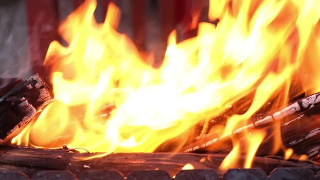Open fire in iron barbecue stove