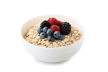 Oat flakes in bowl with berries isolated on white background