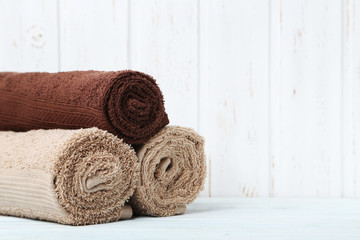 Beige and brown towel on white wooden table