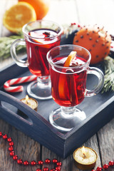 Mulled wine in glass on grey wooden table
