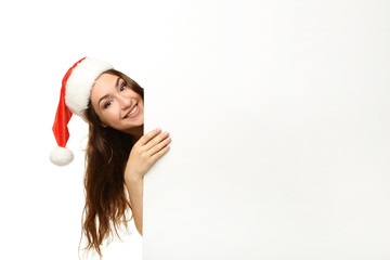 Young woman in santa hat with blank paper on white background
