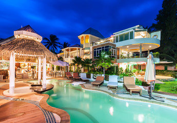 Obraz na płótnie Canvas Luxury resort with swimming pool and restaurant at twiligh