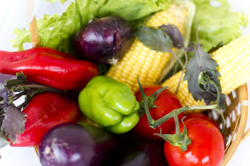 Autumn vegetables: corn, aubergine, tomatoes, pepper, lettuce, basil, onion 