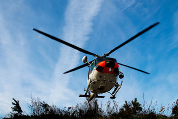 A rescue helicopter taking off from a helipad