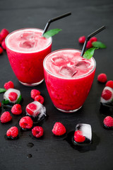Raspberry cold refreshing cocktail with ice and berries. Tasty cocktail