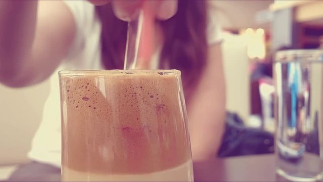 Stirring ice coffee frappe