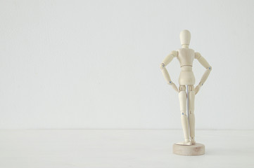 wooden person standing with his back looking at empty white space concept