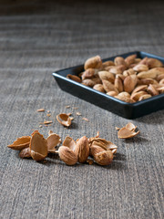 Group almond on black dish and cloth.