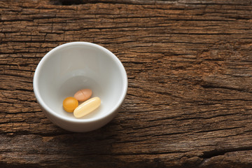 Medications in a white cup