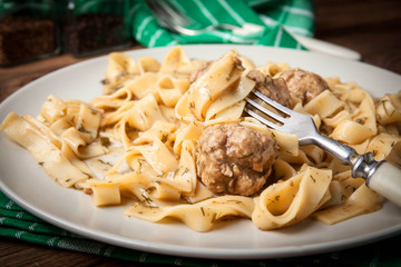 Tagliatelle pasta with beef meatballs.