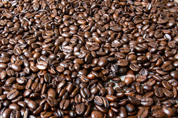 Macro shot of coffee beans on top of a white surface