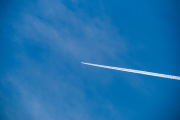 Airplanes leaves trace on clear blue sky. The trace called contrails, condensation trails or vapor trails,