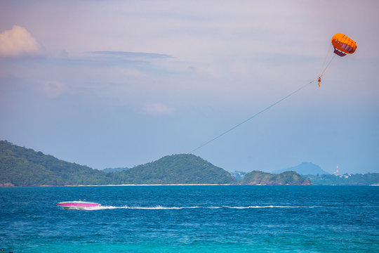Parasailing is a popular pastime in any beach around the world. The active form of relaxation. Focus at parachute.