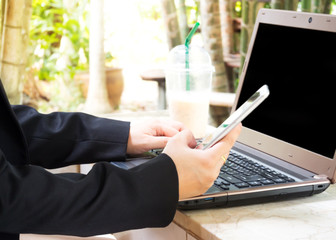 Business and blur background. Woman use smart phone with computer. Garden view background. Concept of communication business can connect around the word when use internet and technology.