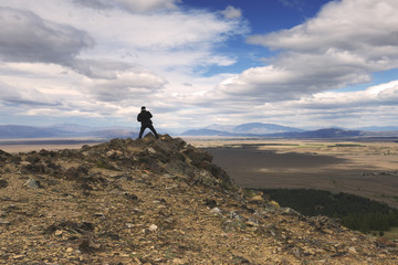 A man standing on top of mountain. A travel and explore concept.