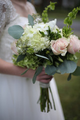 Bride Holding a Pink, White and Green Wedding Bouquet