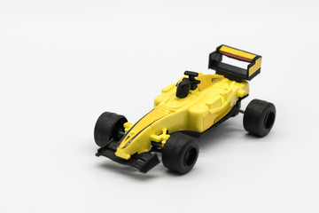 Obraz premium Yellow toy as formula car isolated on white
