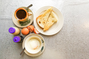 Obraz na płótnie Canvas Asian traditional breakfast half boiled eggs, toast bread and coffee