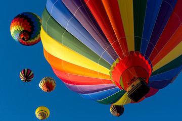 Festival of Ballooning. Colorful hot air balloon flying in the bright blue sky. © KRIDSADA
