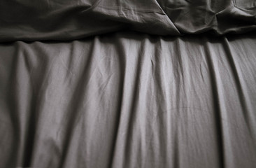 Wrinkled bedsheets and shadow