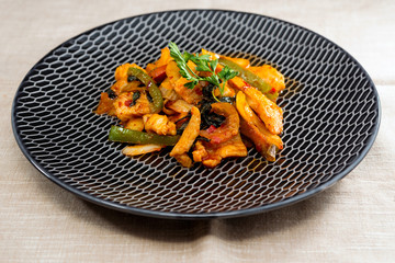 wok fried chicken stir fry with sweet peppers and chinese vegetables