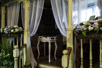 Luxurious vintage gazebo with a tea table and white flowers