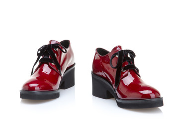 Stylish female shoes in red on a white background