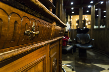 Fototapeta na wymiar Hairdresser's chair in a wooden vintage room