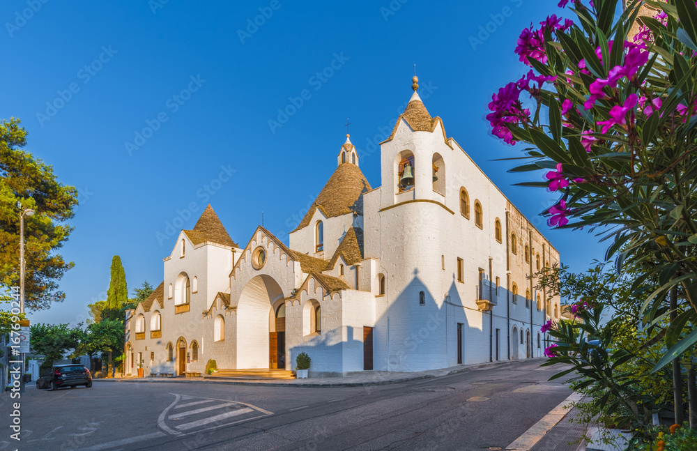 Wall mural a trullo-church, church of trulli village, alberobello, apulia, italy.