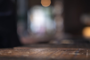 Vintage wooden table with blur bokeh background on cafe