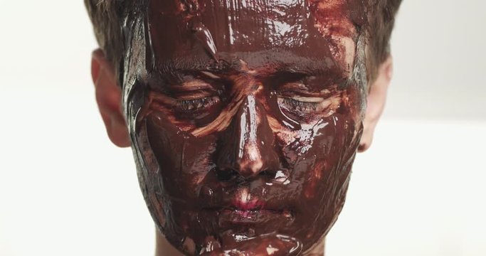 women with a chocolate facial mask has a facial treatment
