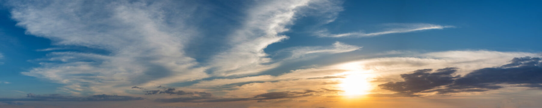 Vibrant color panoramic sun rise and sun set sky with cloud on a cloudy day. Beautiful cirrus cloud. Panorama high resolution photograph.