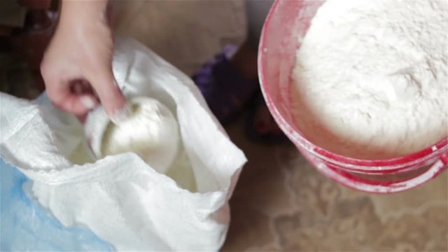 Take flour/A woman takes flour for baking bakery products