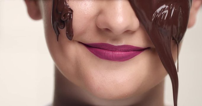 women with a chocolate facial mask has a facial treatment