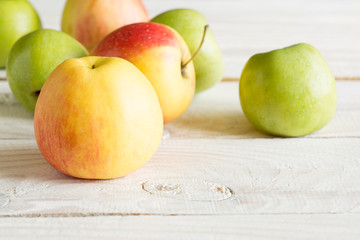 Ripe apples on a wooden background