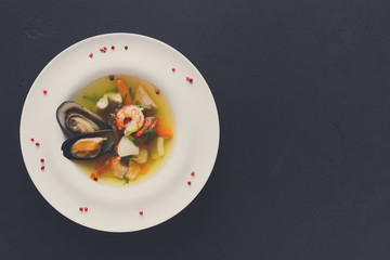 French seafood soup with white fish, shrimps and mussels in plat