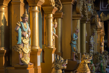 Several statues at the Shwedagon Pagoda in Yangon, Myanmar on a sunny day.