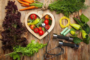Sport and diet. Fresh vegetables. Healthy lifestyle. Rustic wooden background. - 167696446