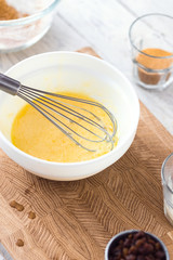 MIxing baking ingredients, egg yolks and milk, in a bowl for cake or pancakes. Light food...