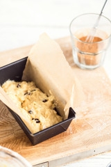 Raw cinnamon loaf cake dough in a pan. Step by step baking preparation process. White food photography