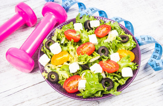 Greek salad with fresh vegetables, feta cheese and black olives.